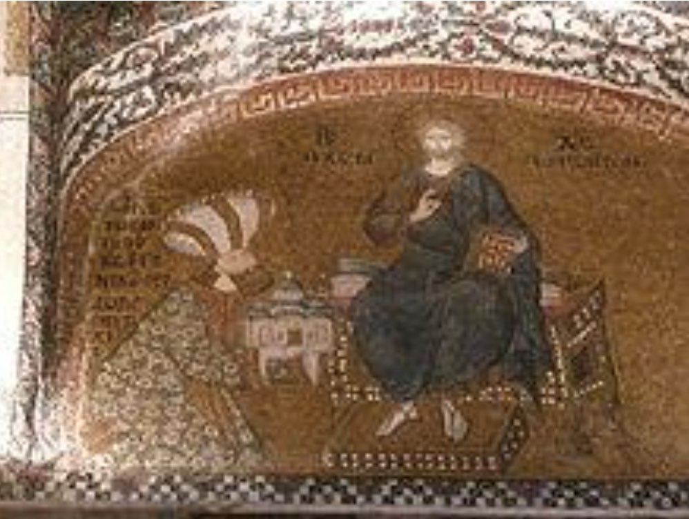 Byzantine mosaic fragment showing a seated figure with a halo holding a scroll, within a semi-circular decorative arch, against a richly patterned golden background